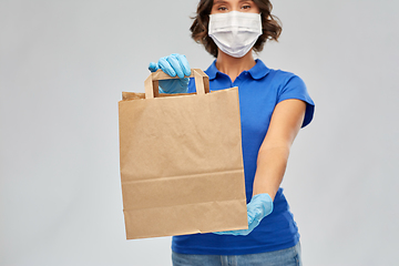 Image showing delivery woman in face mask with paper bag