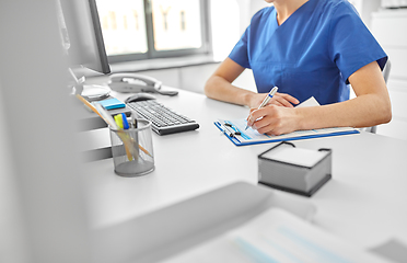 Image showing doctor or nurse with clipboard at hospital