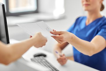 Image showing doctor and patient with prescription at hospital