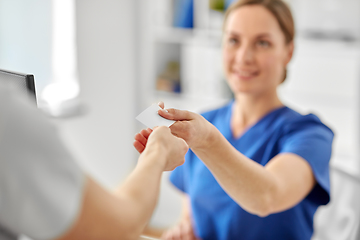 Image showing patient giving tag to doctor or nurse at hospital