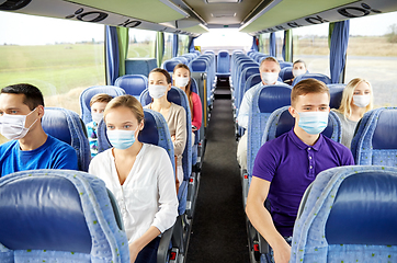 Image showing group of passengers in medical masks in travel bus