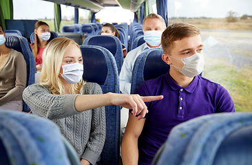 Image showing couple of passengers in masks in travel bus