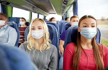 Image showing young women passengers in masks in travel bus