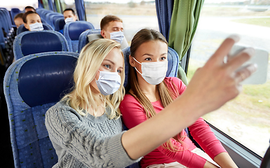 Image showing women taking in masks selfie in travel bus