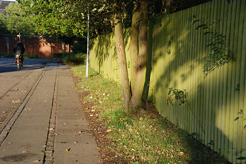 Image showing Fence with bicycle in sunset