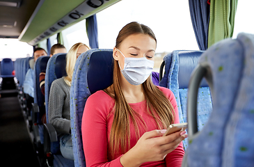 Image showing woman in mask with smartphone in travel bus