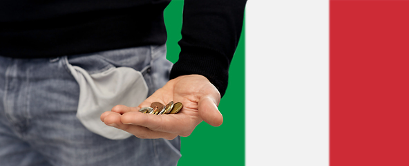 Image showing close up of man showing coins and empty pockets