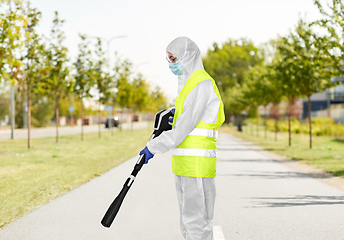 Image showing sanitation worker in hazmat with pressure washer