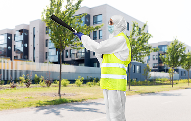 Image showing sanitation worker in hazmat with pressure washer