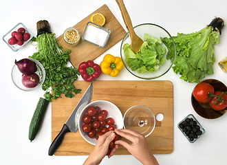 Image showing woman with cherry tomatoes at kitchen