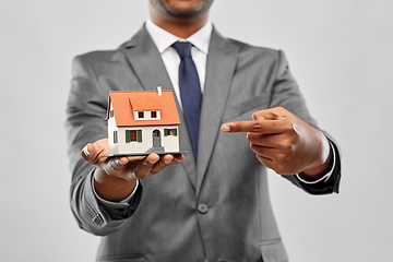 Image showing indian man realtor with house model and folder