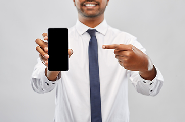 Image showing smiling indian businessman showing smartphone