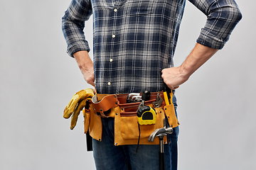 Image showing male worker or builder with working tools on belt