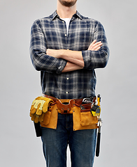 Image showing male worker or builder with working tools on belt