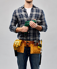 Image showing male repairer or builder with drill and work tools