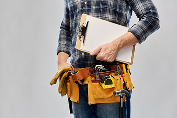 Image showing male builder with clipboard and working tools