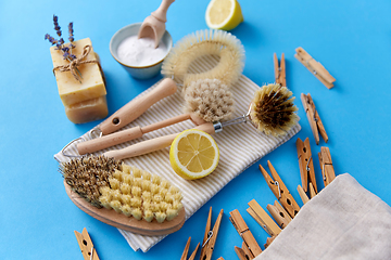 Image showing cleaning brushes, lemon and wooden clothespins