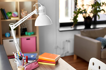 Image showing room with lamp and school supplies on table