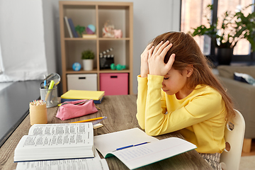 Image showing stressed little student girl learning at home