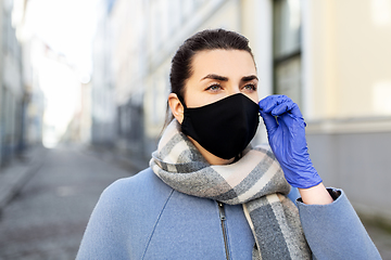 Image showing woman wearing protective reusable mask in city