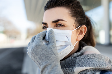 Image showing woman wearing protective medical mask in city