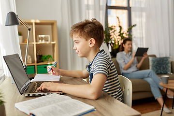 Image showing student boy with laptop learning at home