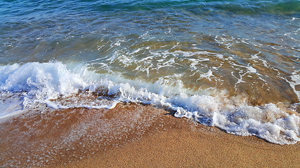 Image showing Sea water with white foam on the coastal sand