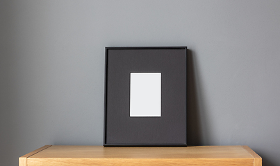 Image showing empty frame on wooden shelf