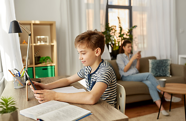 Image showing student boy with tablet computer learning at home