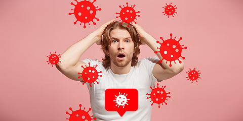 Image showing Young man scared of coronavirus spreading and worldwide cases, shocked, keeping quarantine