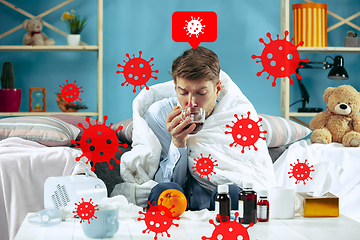 Image showing Young man scared of coronavirus spreading and worldwide cases, feeling ill, sick, fever