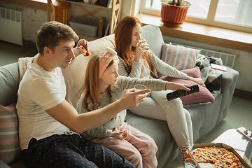 Image showing Family spending nice time together at home, looks happy and cheerful, eating pizza