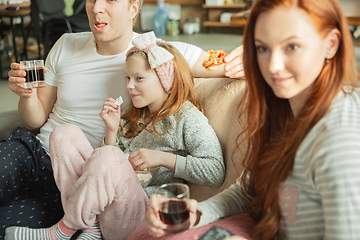 Image showing Family spending nice time together at home, looks happy and cheerful, eating pizza