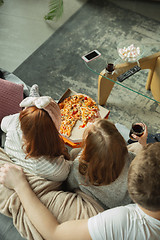 Image showing Family spending nice time together at home, looks happy and cheerful, eating pizza. Top view.