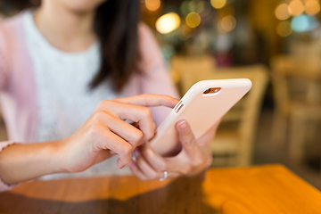 Image showing Woman using mobile phone in coffee shop