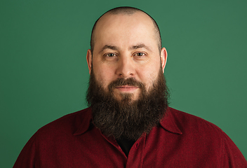 Image showing Handsome caucasian man portrait isolated on green studio background with copyspace