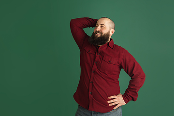 Image showing Handsome caucasian man portrait isolated on green studio background with copyspace