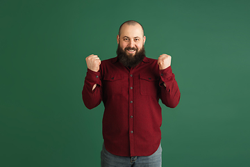 Image showing Handsome caucasian man portrait isolated on green studio background with copyspace