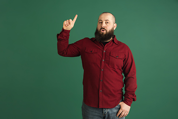 Image showing Handsome caucasian man portrait isolated on green studio background with copyspace