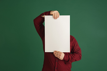 Image showing Handsome caucasian man portrait isolated on green studio background with copyspace