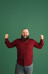 Image showing Handsome caucasian man portrait isolated on green studio background with copyspace