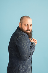 Image showing Handsome caucasian man portrait isolated on blue studio background with copyspace