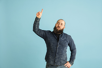 Image showing Handsome caucasian man portrait isolated on blue studio background with copyspace