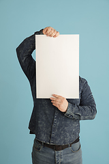 Image showing Handsome caucasian man portrait isolated on blue studio background with copyspace