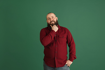 Image showing Handsome caucasian man portrait isolated on green studio background with copyspace