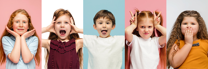 Image showing Young and happy kids gesturing isolated on multicolored studio background. Human emotions, facial expression concept