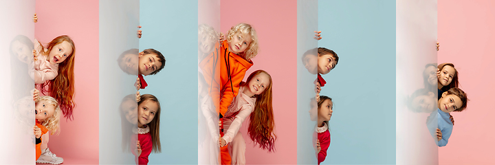 Image showing Young and happy kids gesturing isolated on multicolored studio background. Human emotions, facial expression concept