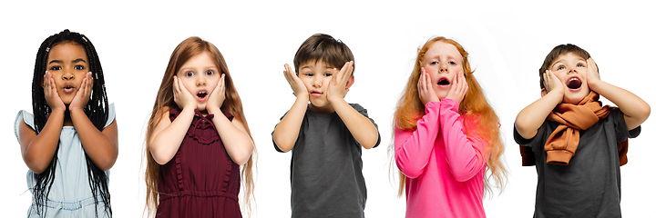 Image showing Little and happy kids gesturing isolated on white studio background. Human emotions, facial expression concept