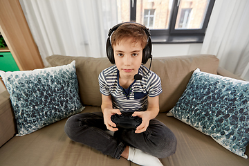 Image showing boy with gamepad playing video game at home