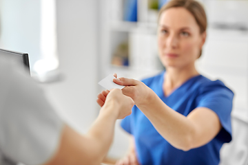 Image showing patient giving tag to doctor or nurse at hospital